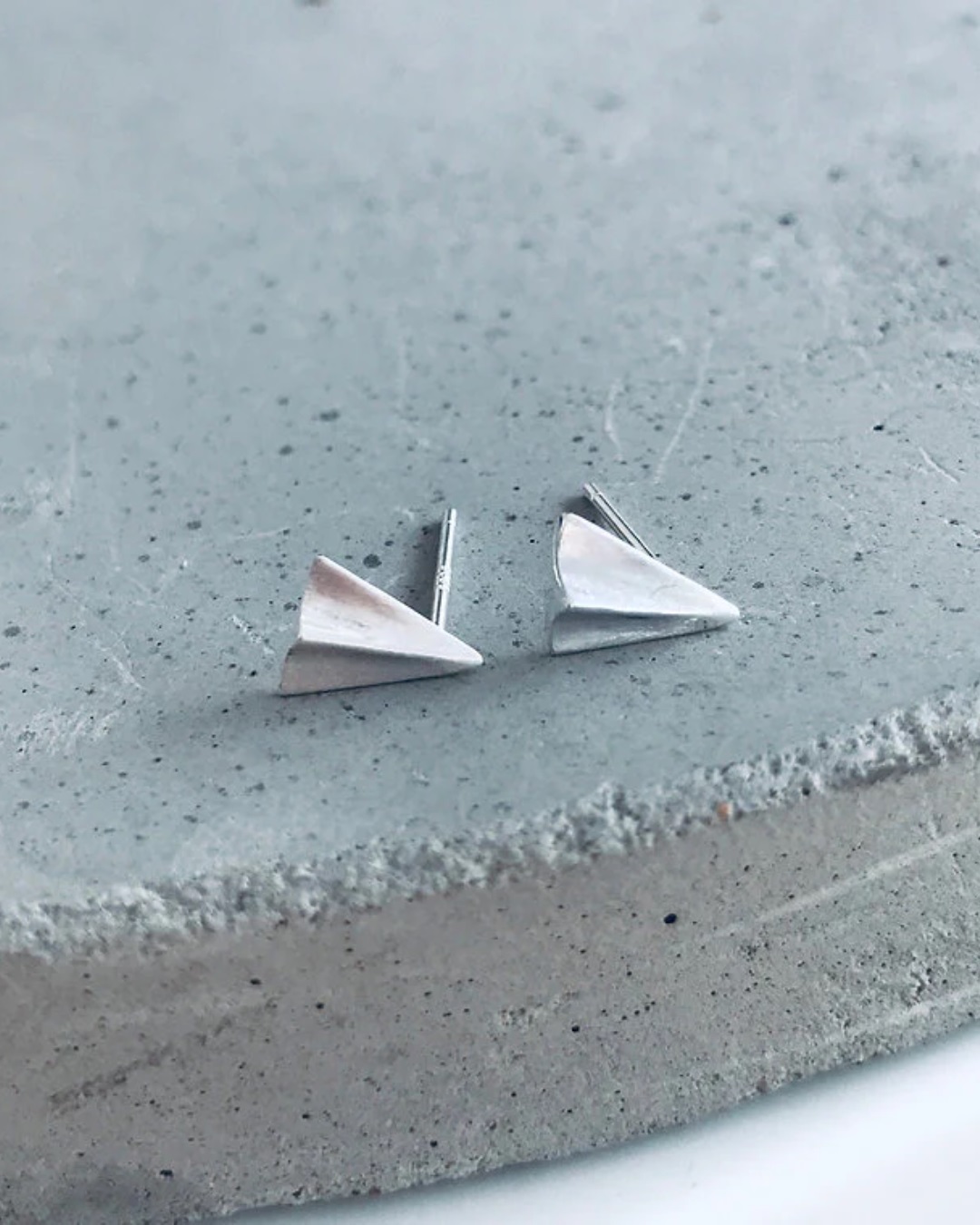 Aeroplane silver stud earrings on stone