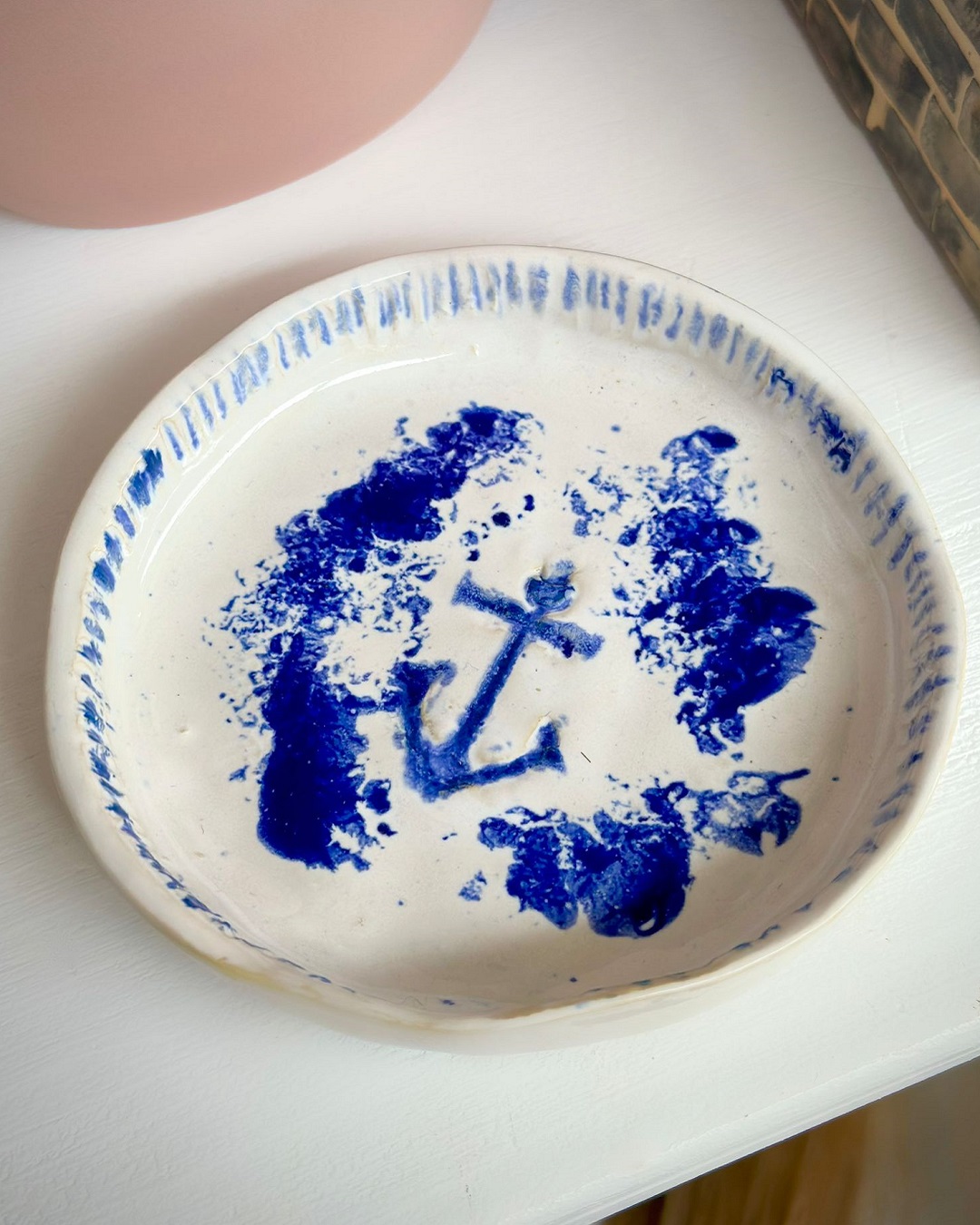 Dish with blue anchor on it