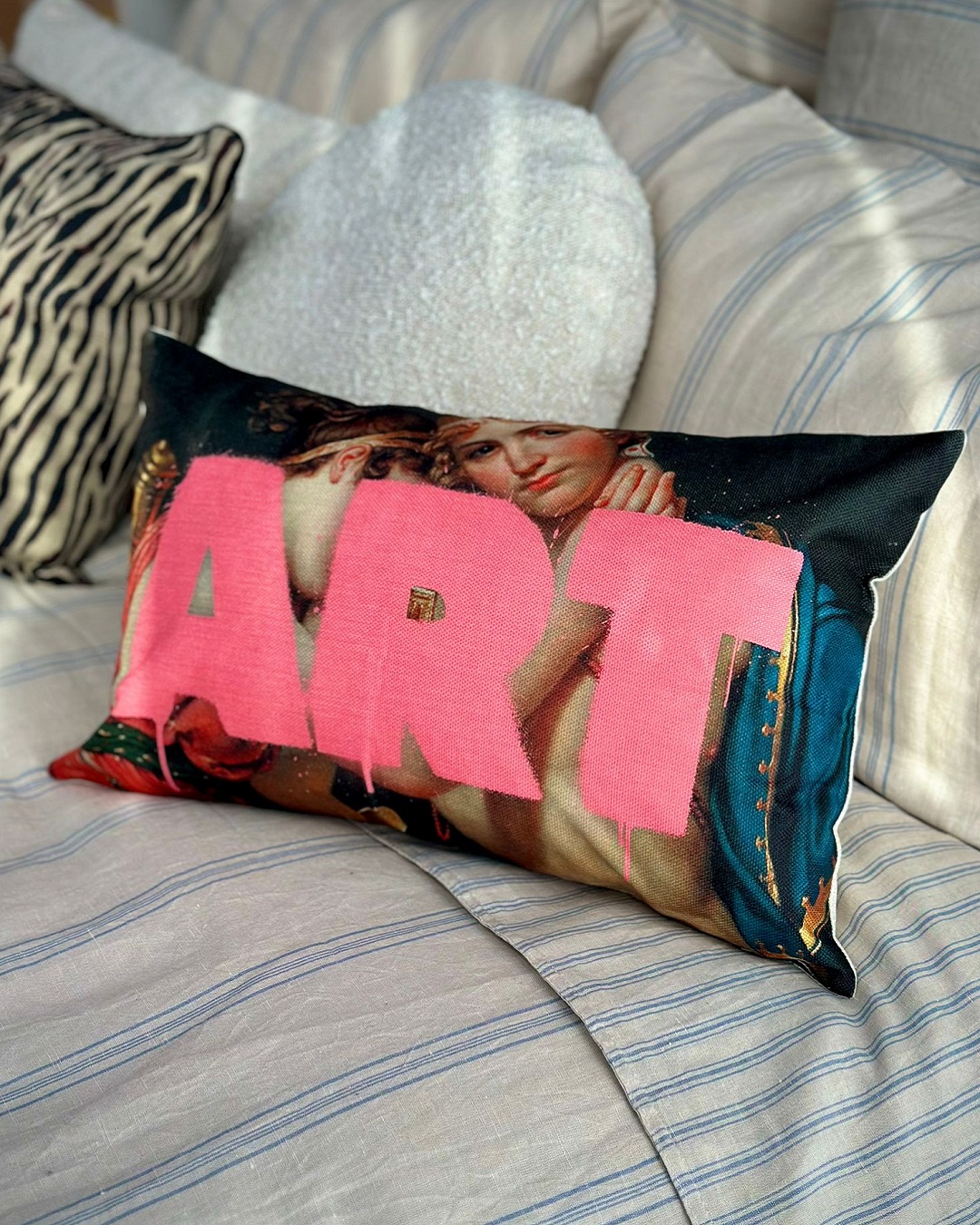 cushion with painting and art in pink on it