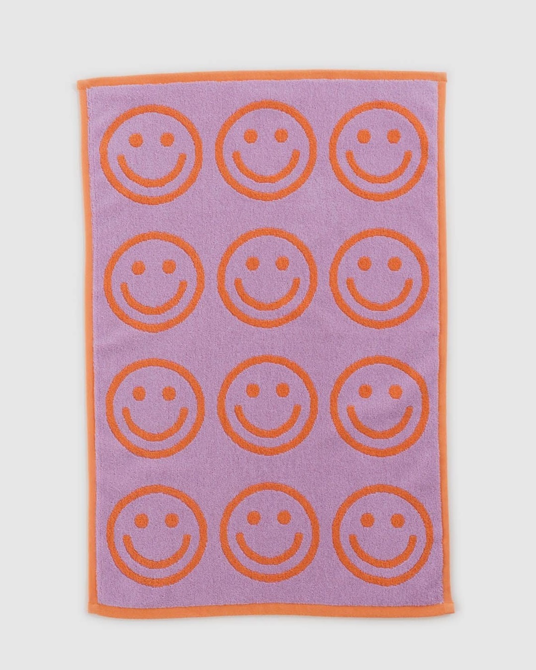 Orange and purple smiley face towel