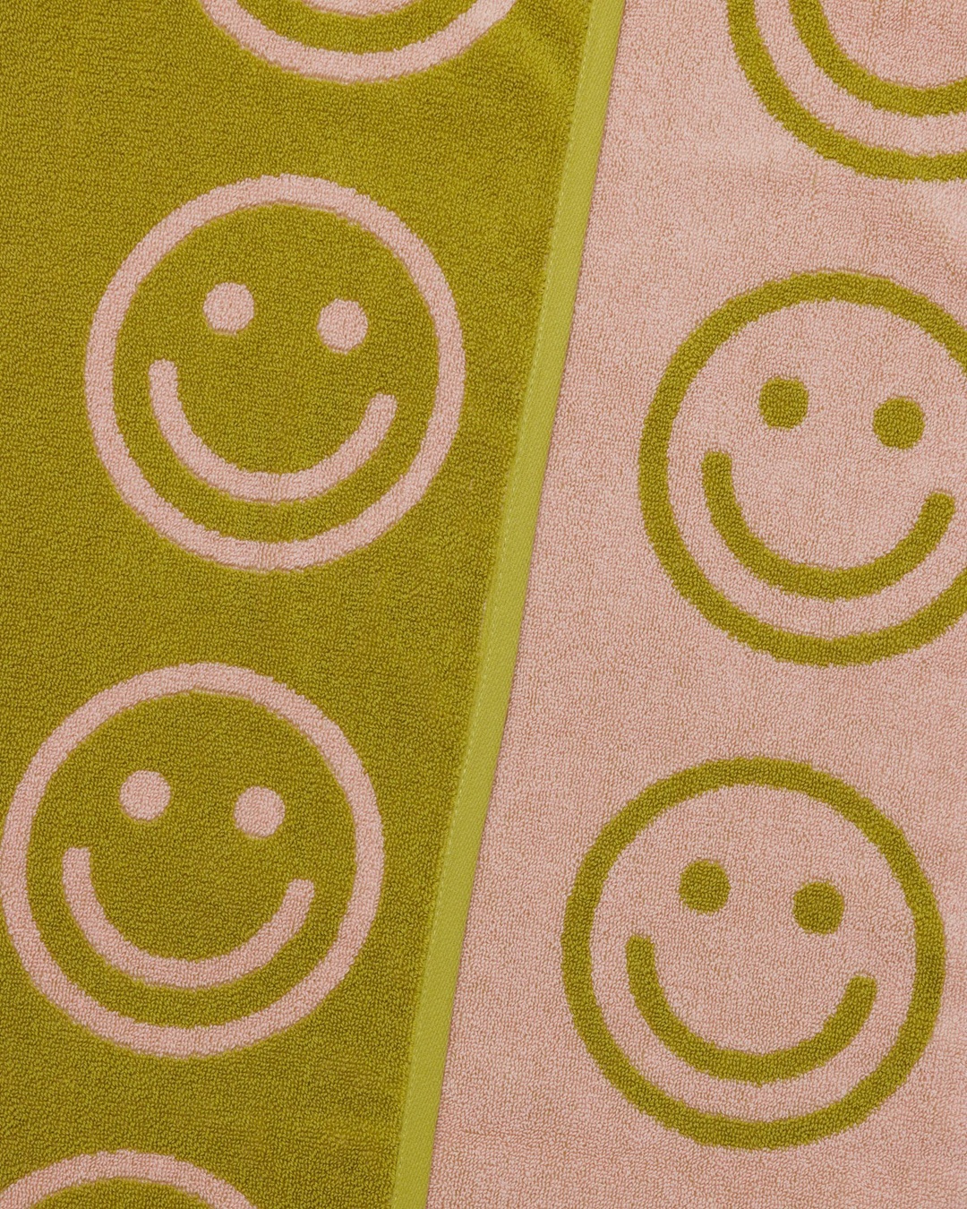 Green and pink smiley face towel