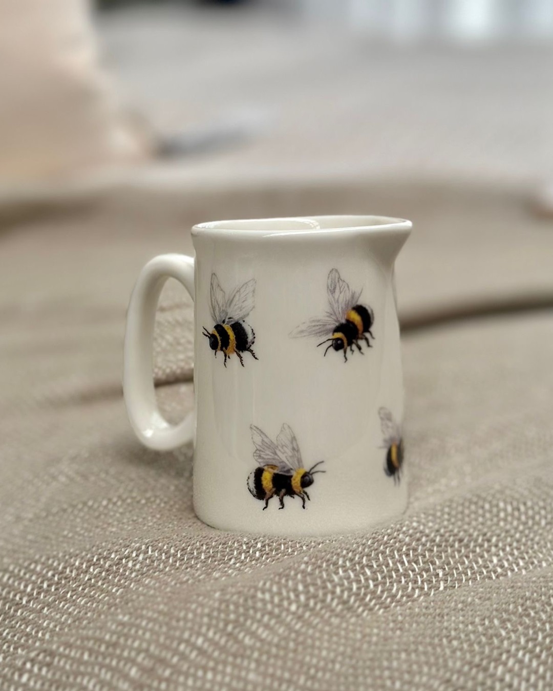 White jug with bumble bees on it