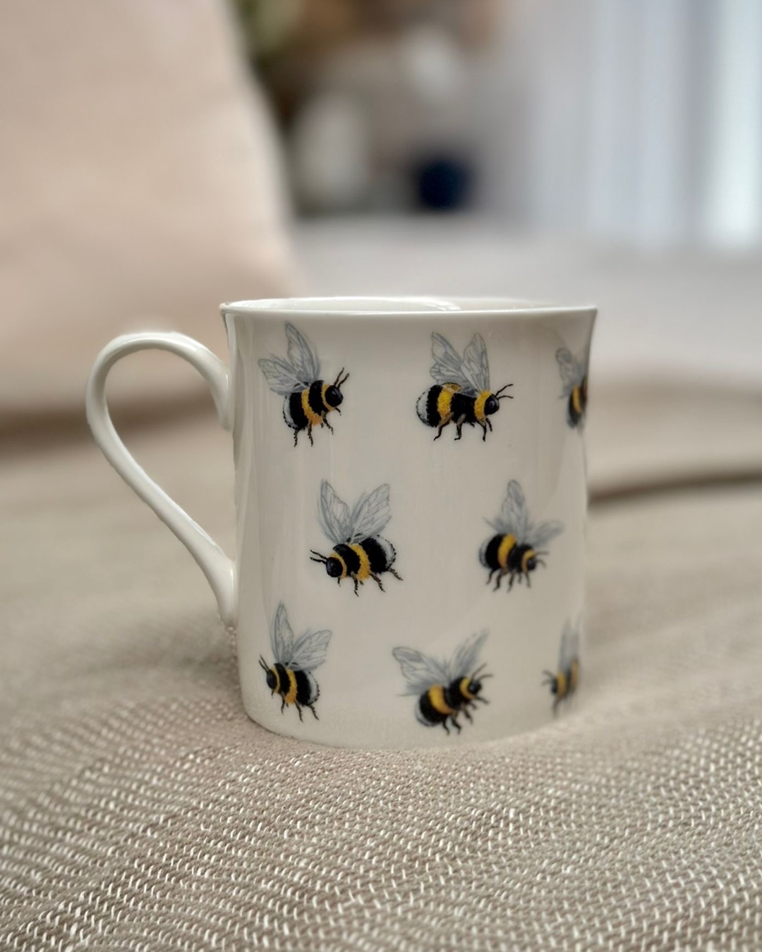White cup with bumble bees on it