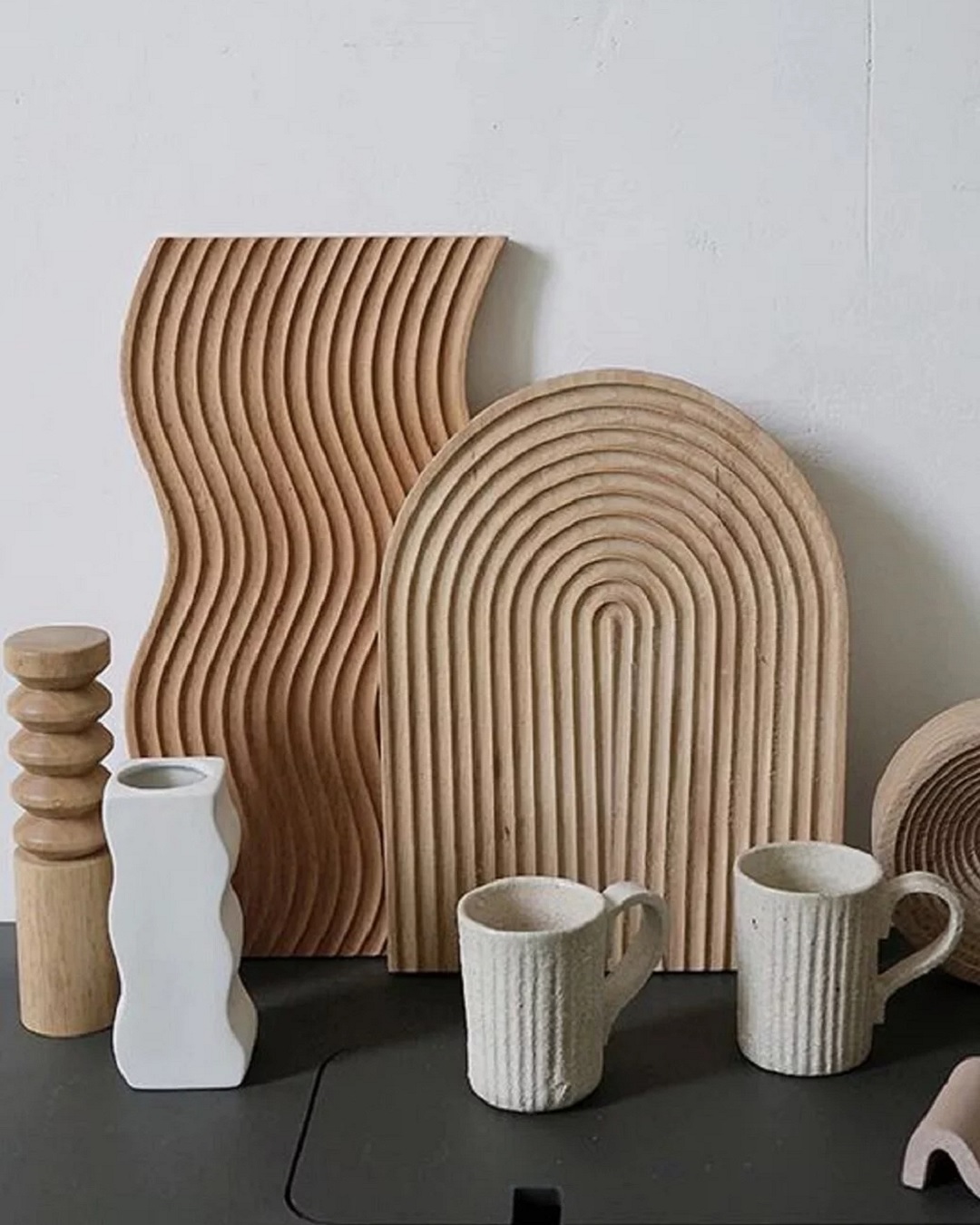 Beech wood chopping boards wave and arch on bench with vases and mugs