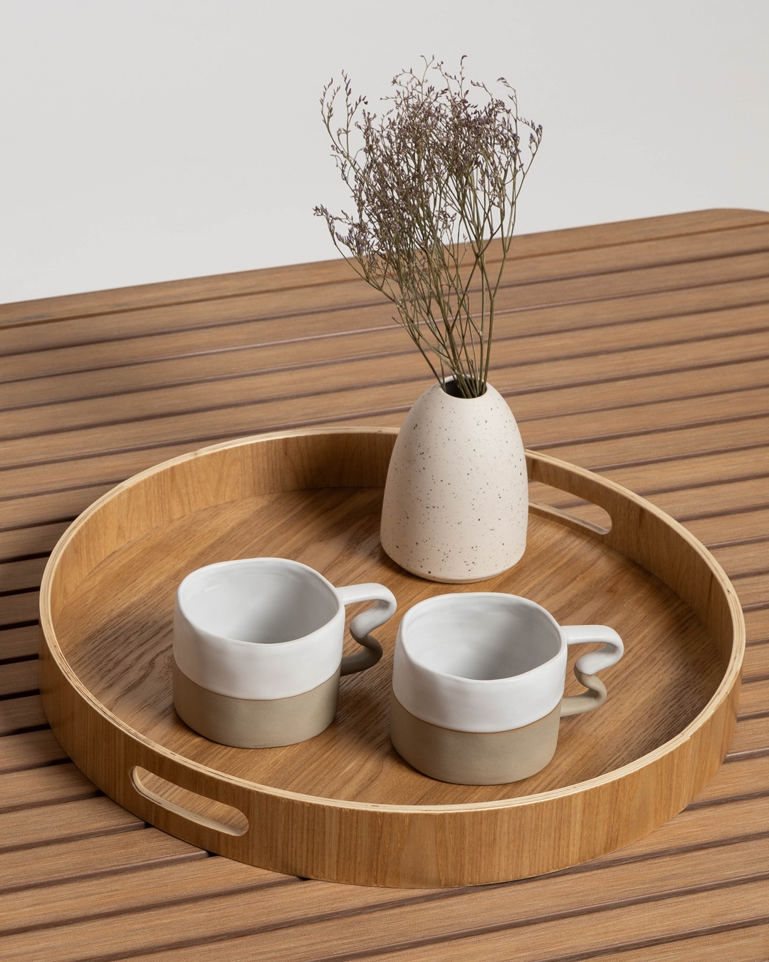 Benni mugs white and sand with squiggle handles on tray with vase on wooden table