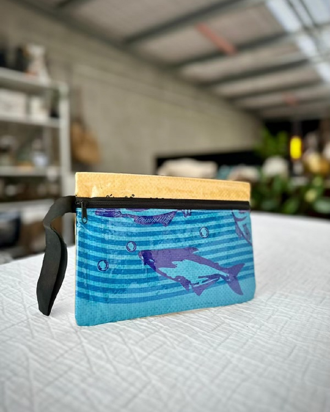 Blue fish purse on bed
