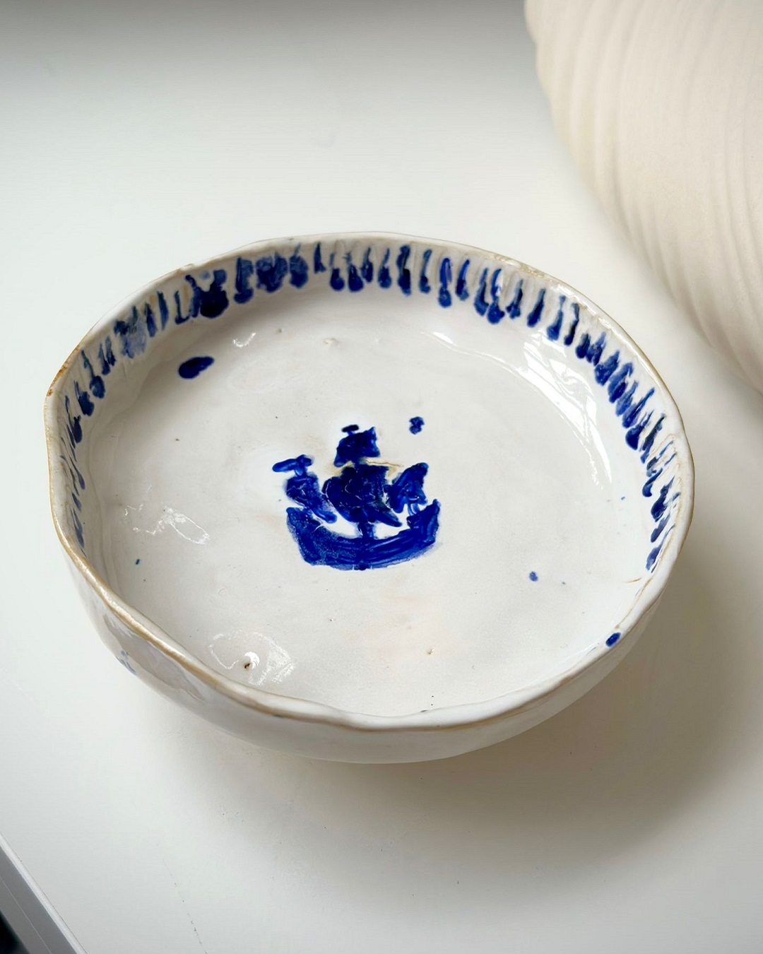 Dish with blue boat on it