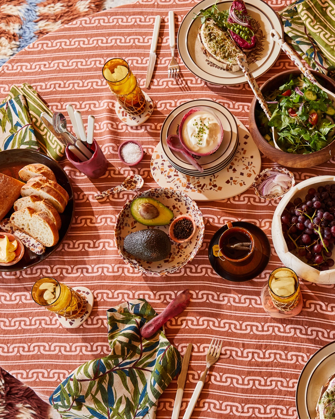 Orange bowls on table cloth with food