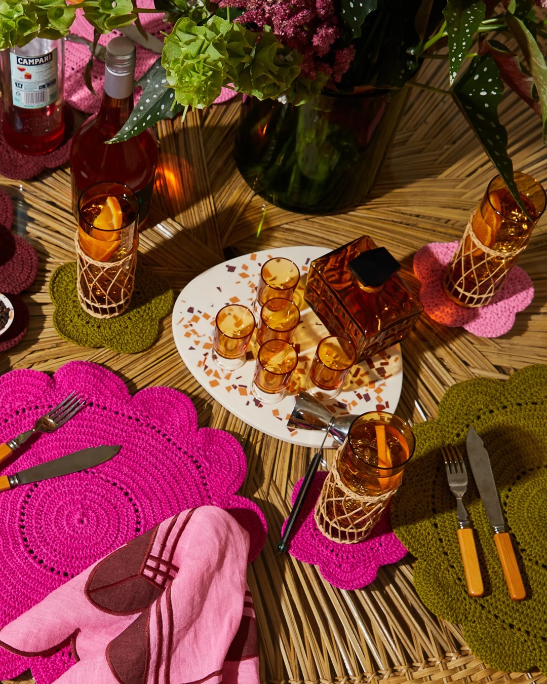 Board in red and orange terrazzo on table with candles