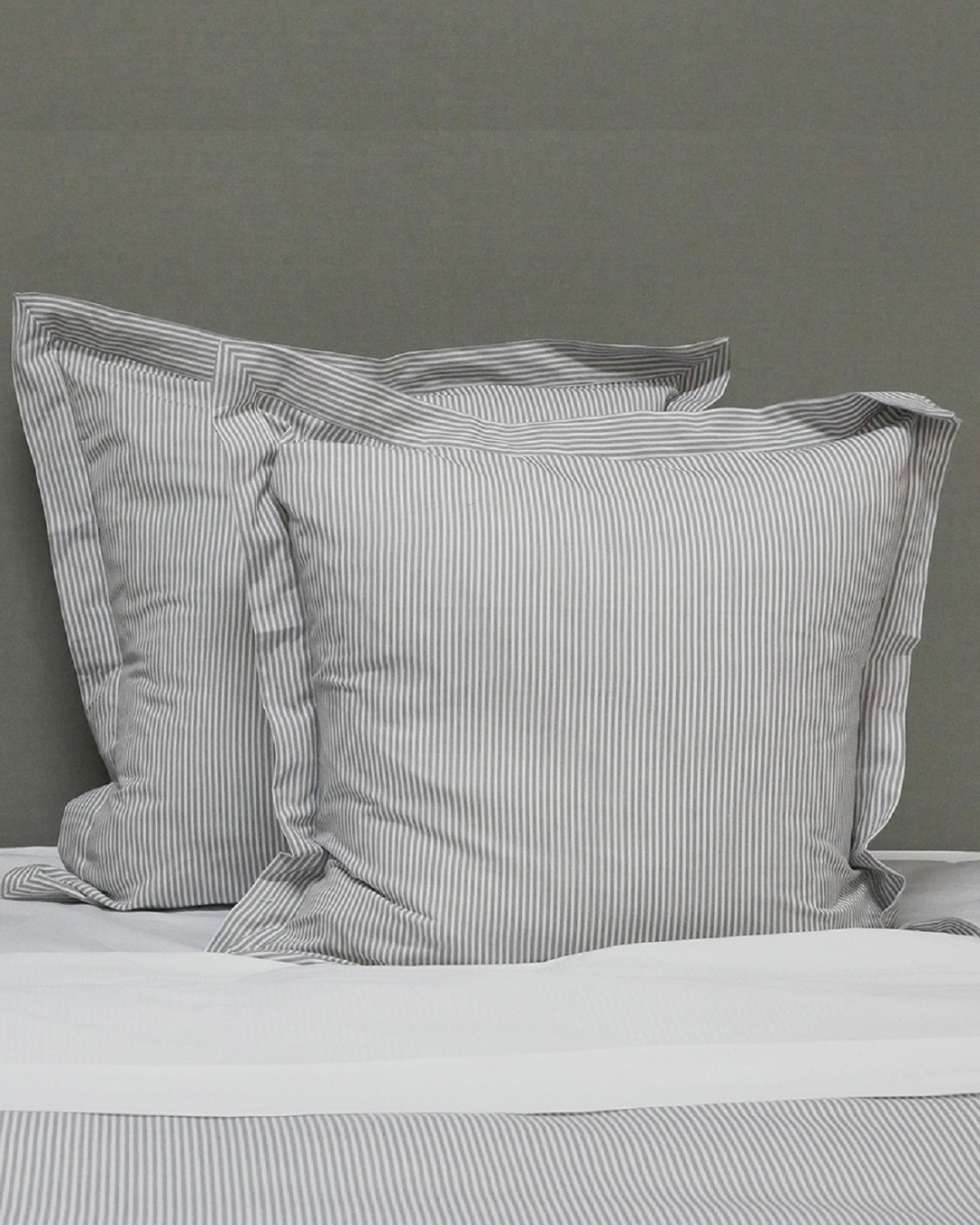 Black stripe euro pillows on bed