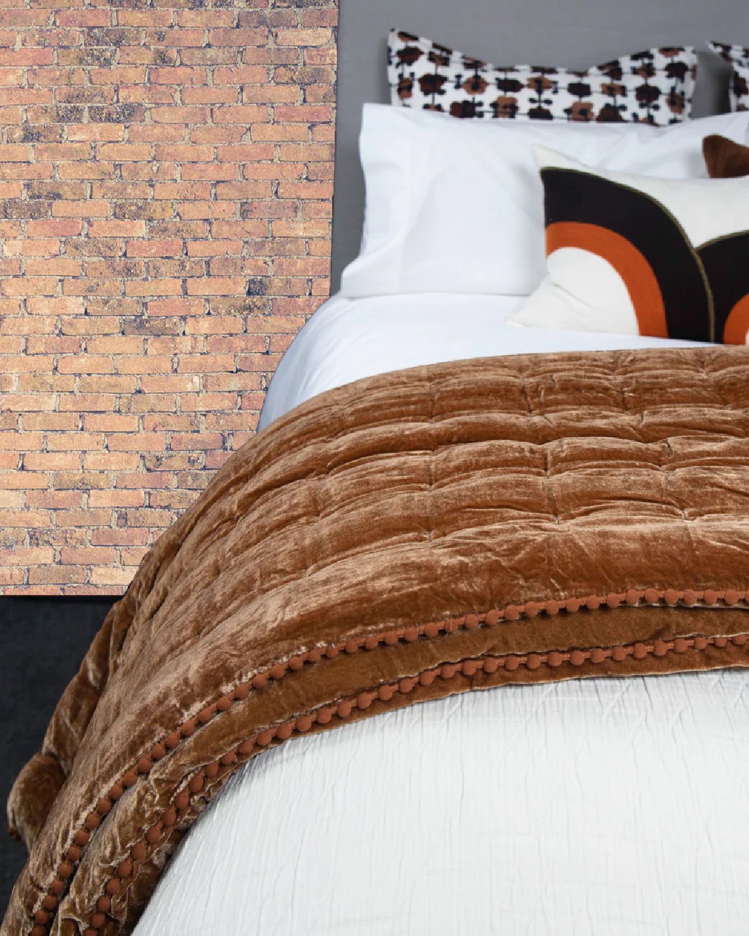 Rusty velvet comforter on white bed