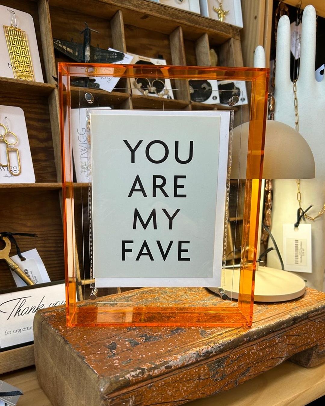 Orange plastic frame with you are my fave inside