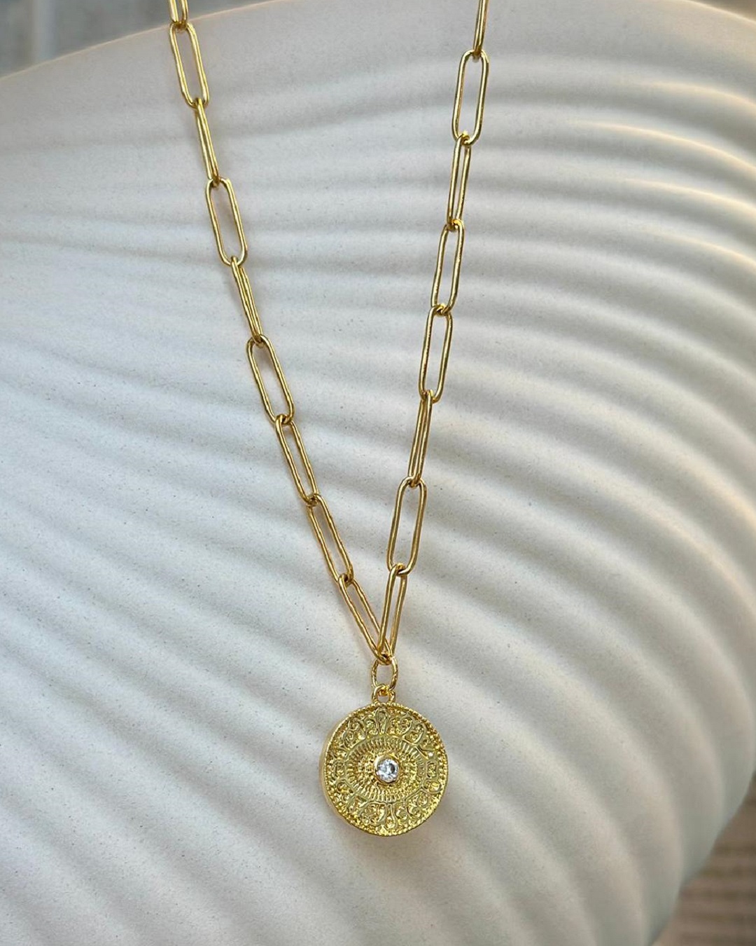 Sun and diamante gold plated necklace on a chain