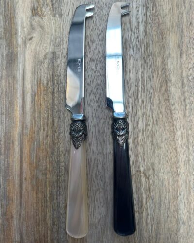 Cheese knives on wooden board
