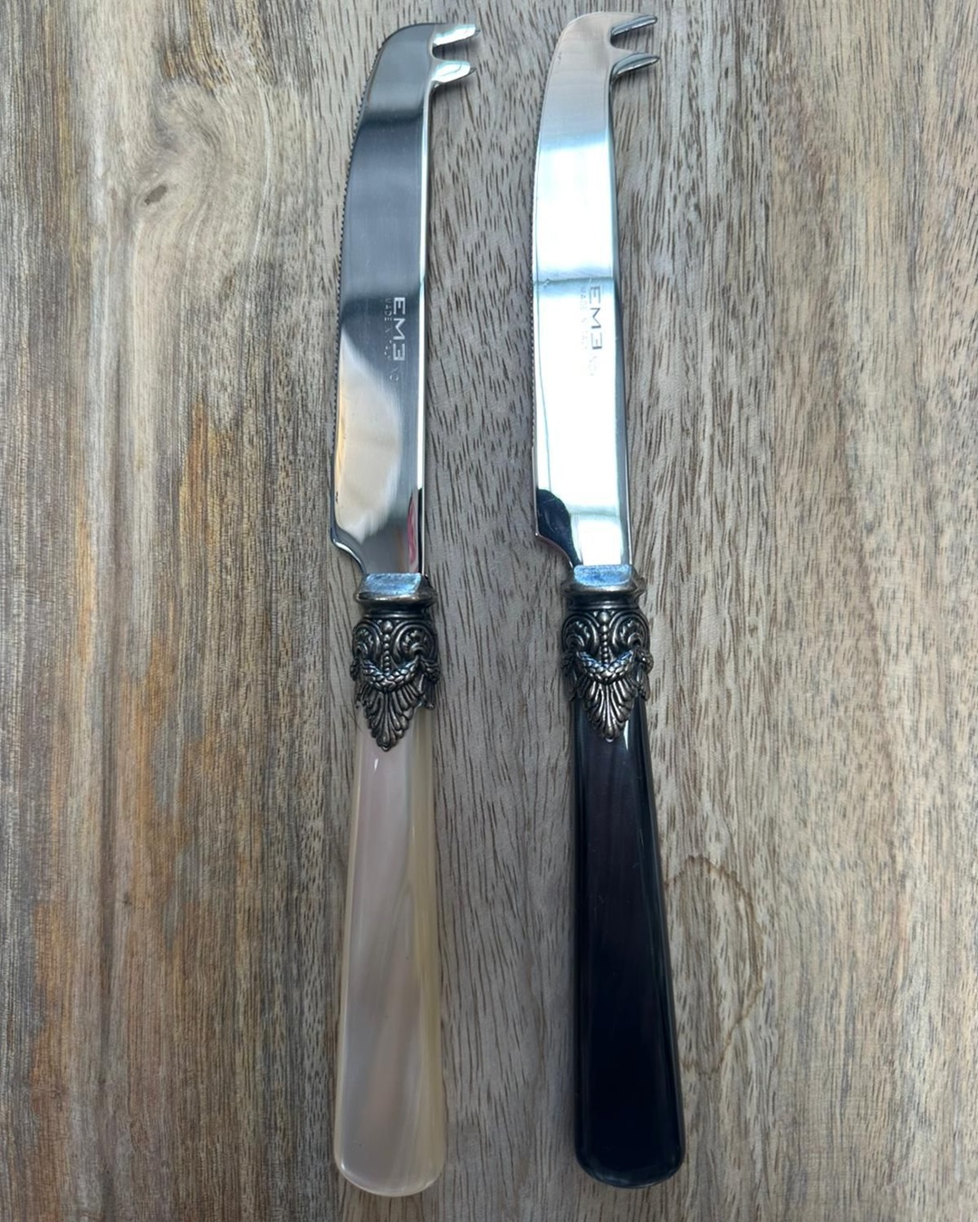 Cheese knives on wooden board