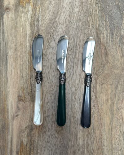Pate knives on wooden board