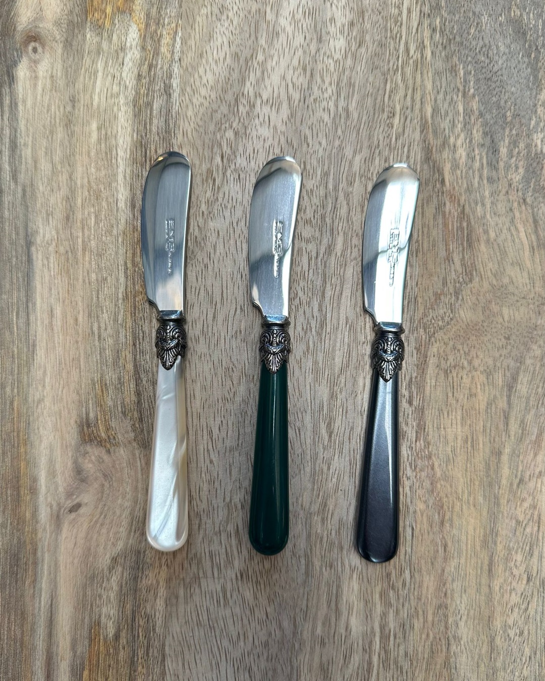 Pate knives on wooden board