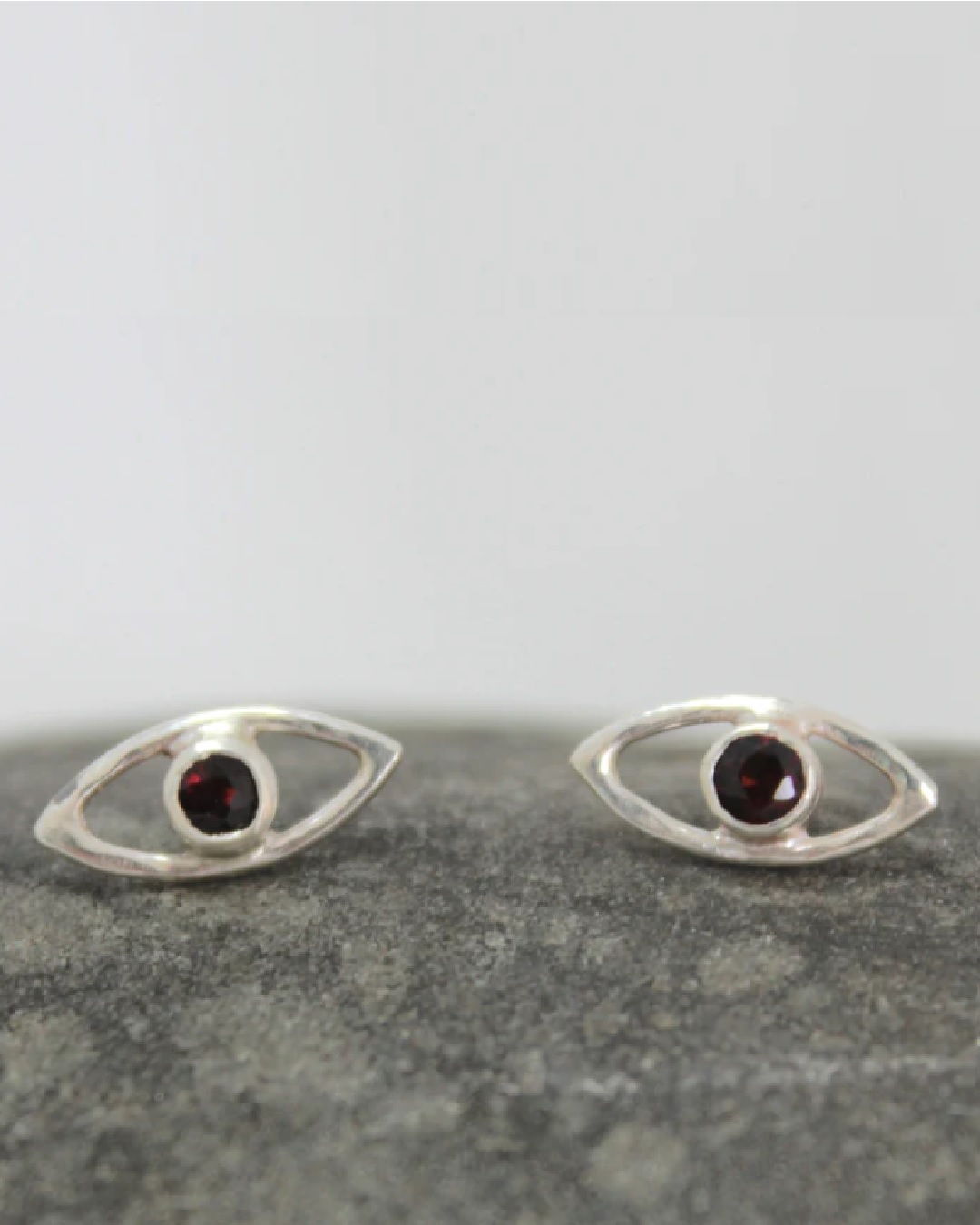 Silver stud earrings eye shape with red jewel in center