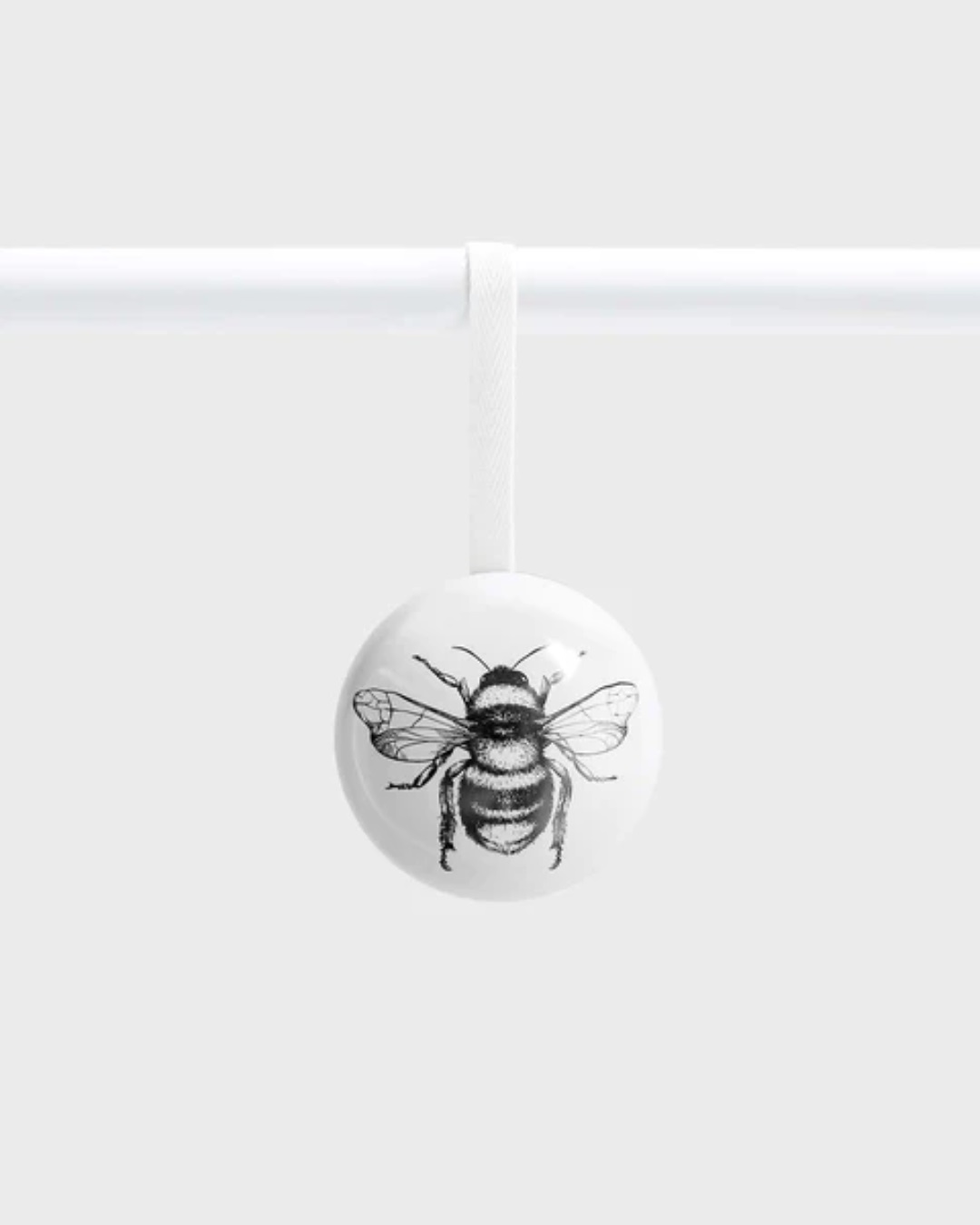 White bauble with black bumble bee