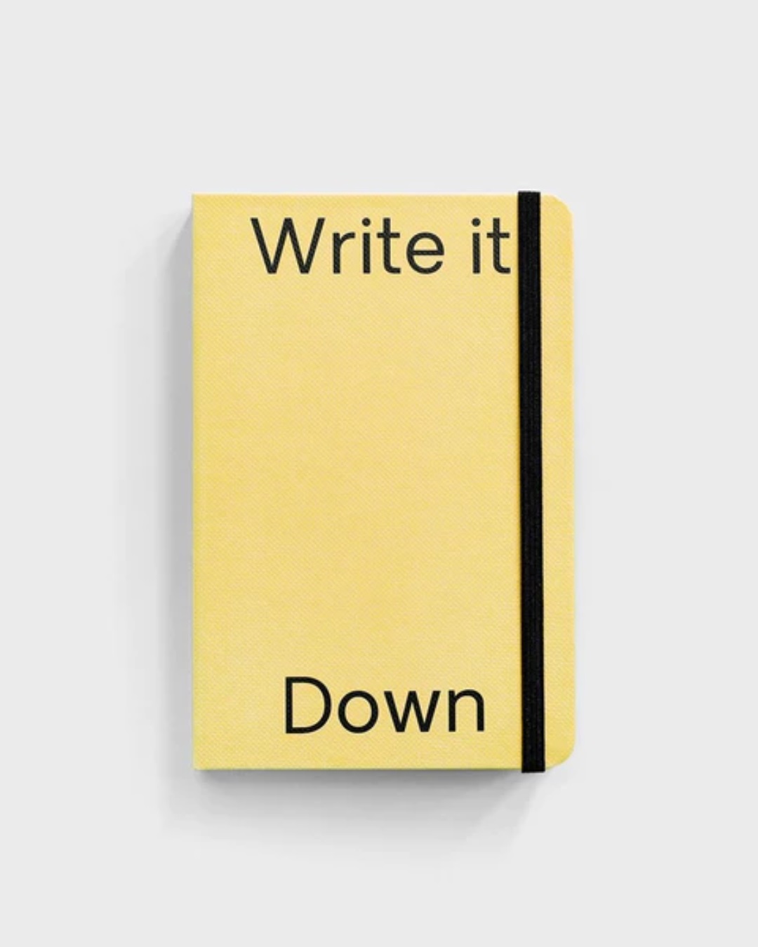 Yellow note book with write it down text