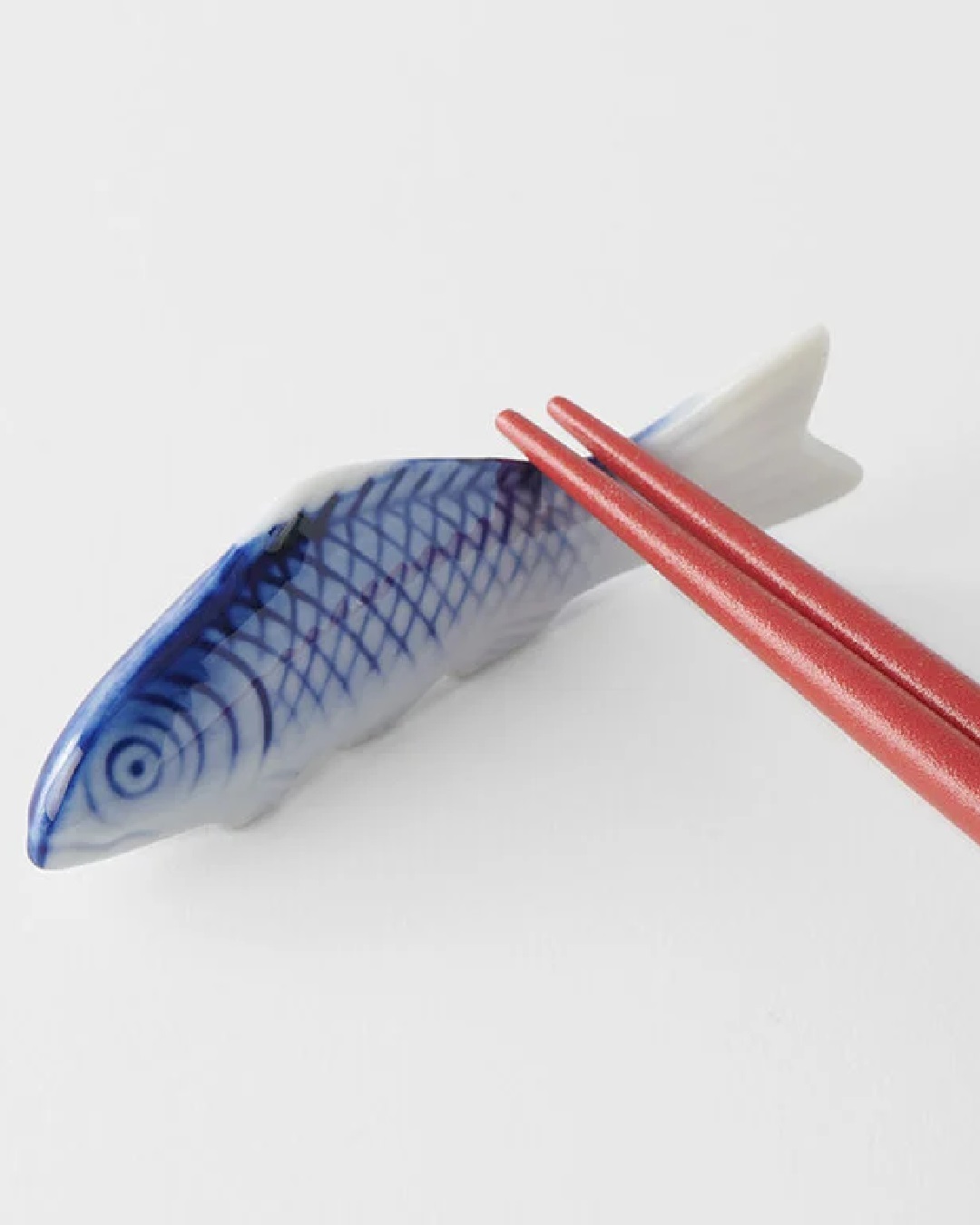 Fish chopstick rest with rest chopstick on it