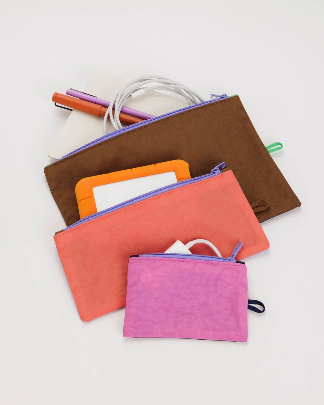 Pink orange and brown flat pouches with stationery in