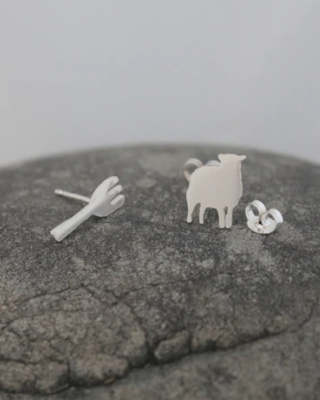 Silver stud earrings one of a fork and one of a ewe