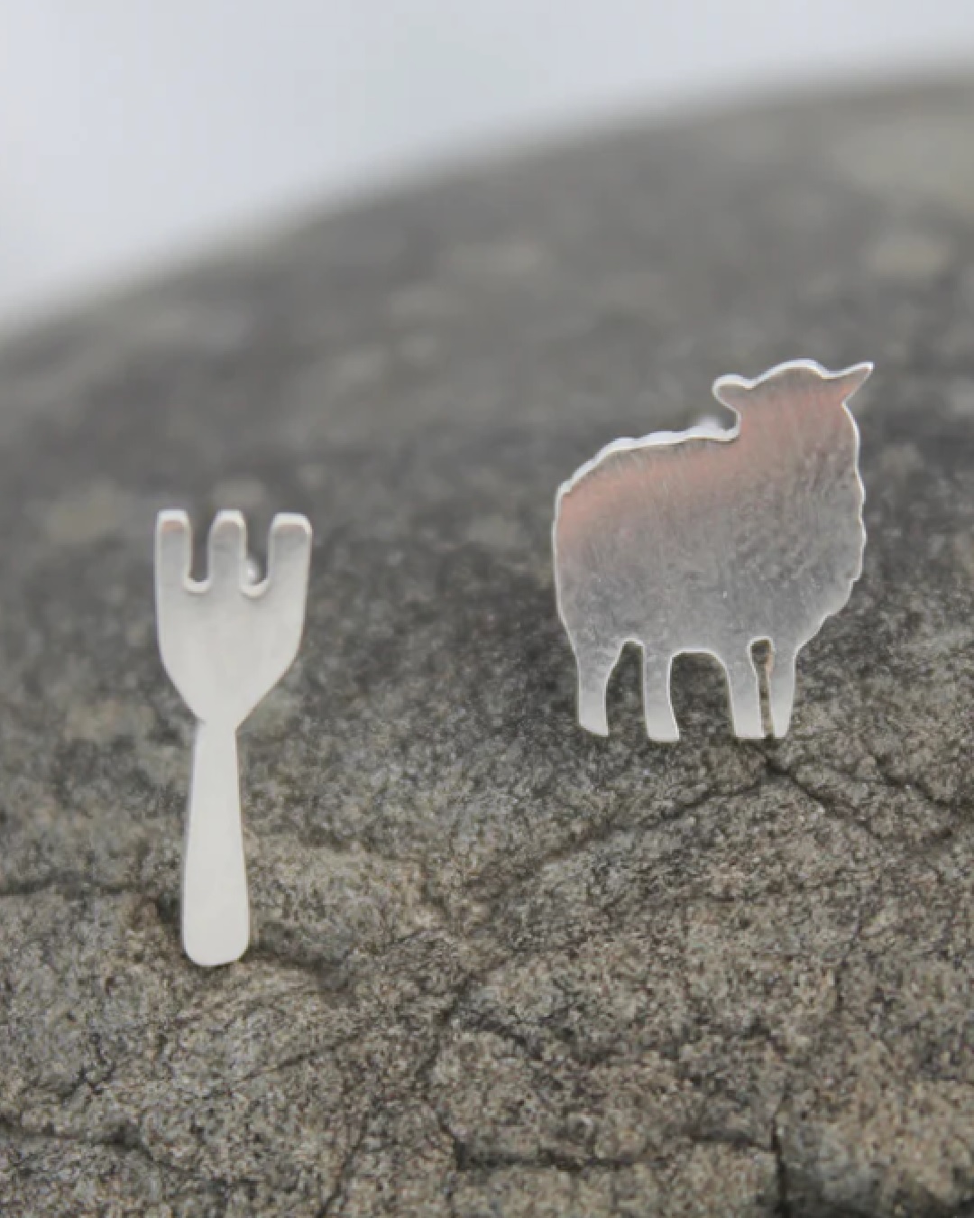 Silver stud earrings one of a fork and one of a ewe