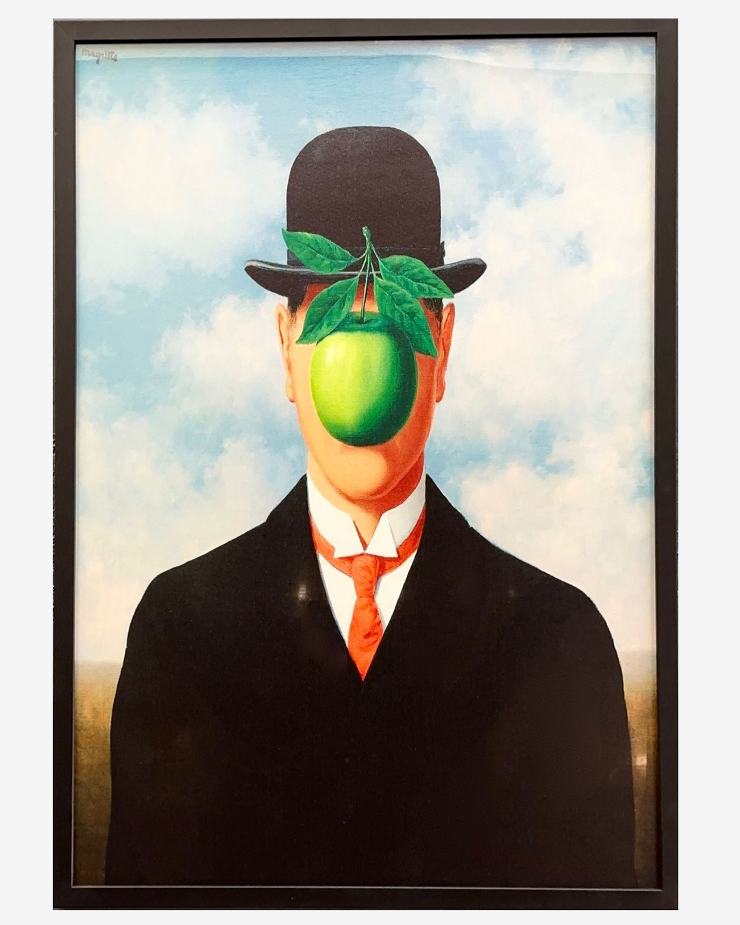 Framed Magritte art print. Man with apple in front of face