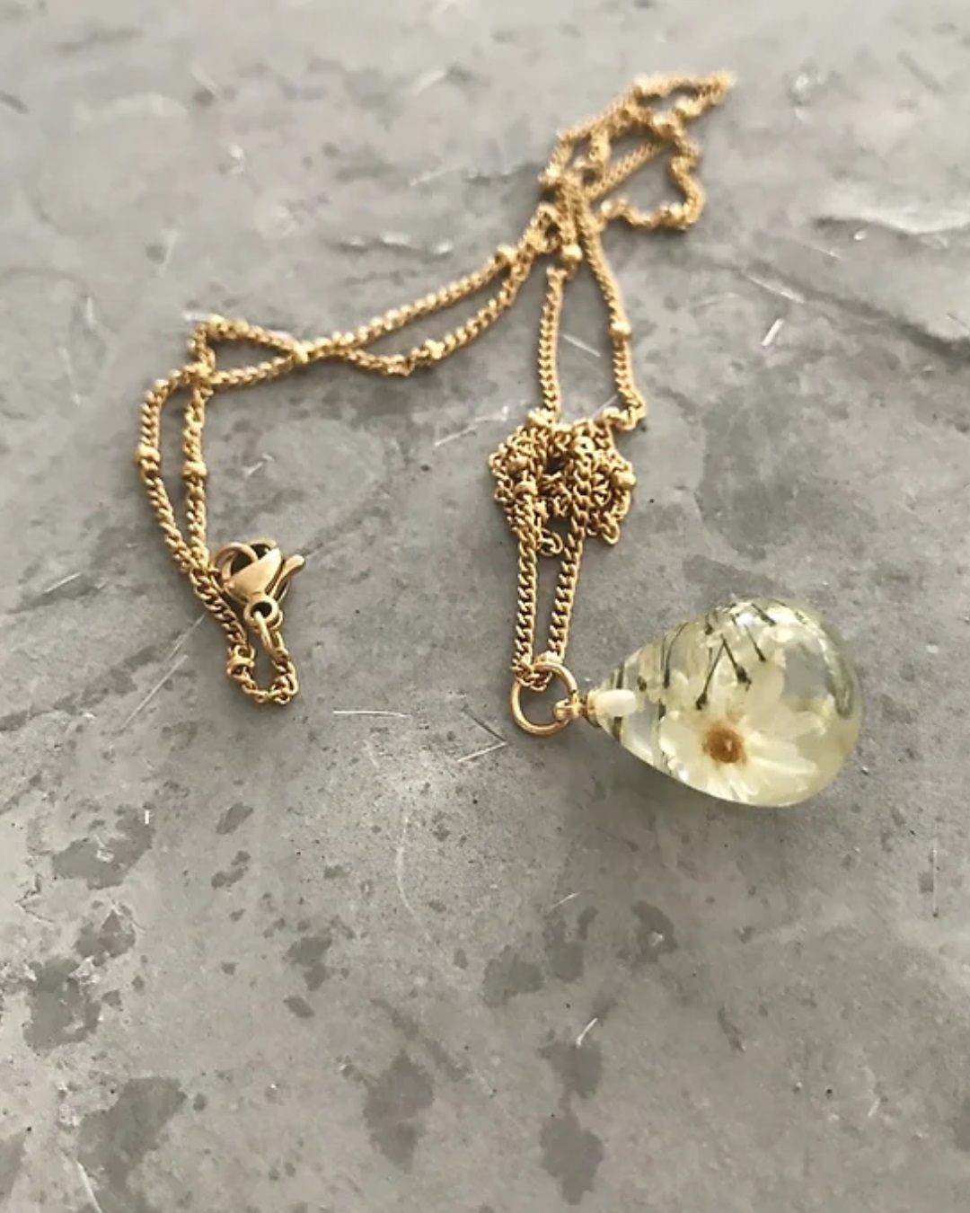 Gold chain necklace with flower in droplet