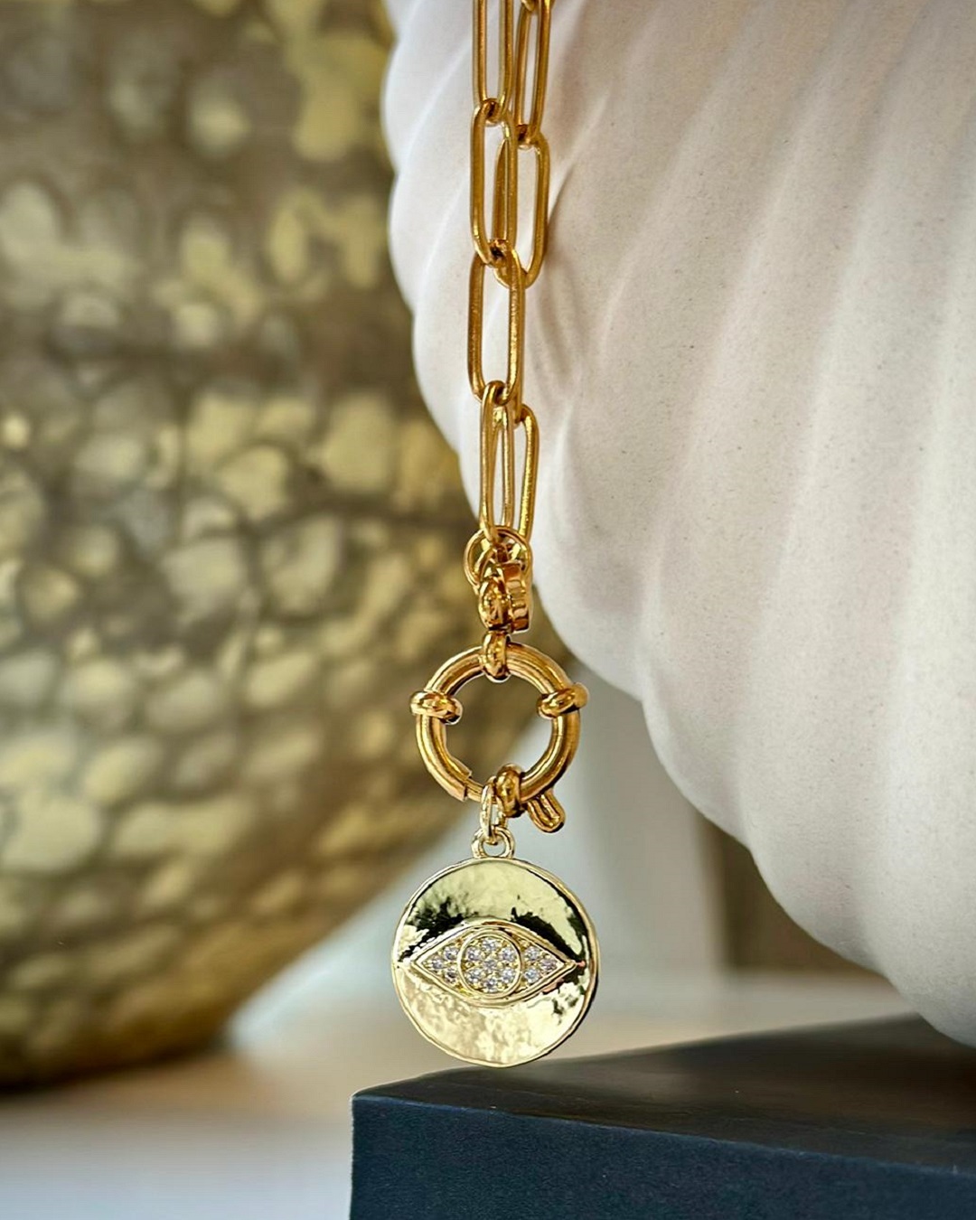 Eye and diamante gold plated necklace on a chain