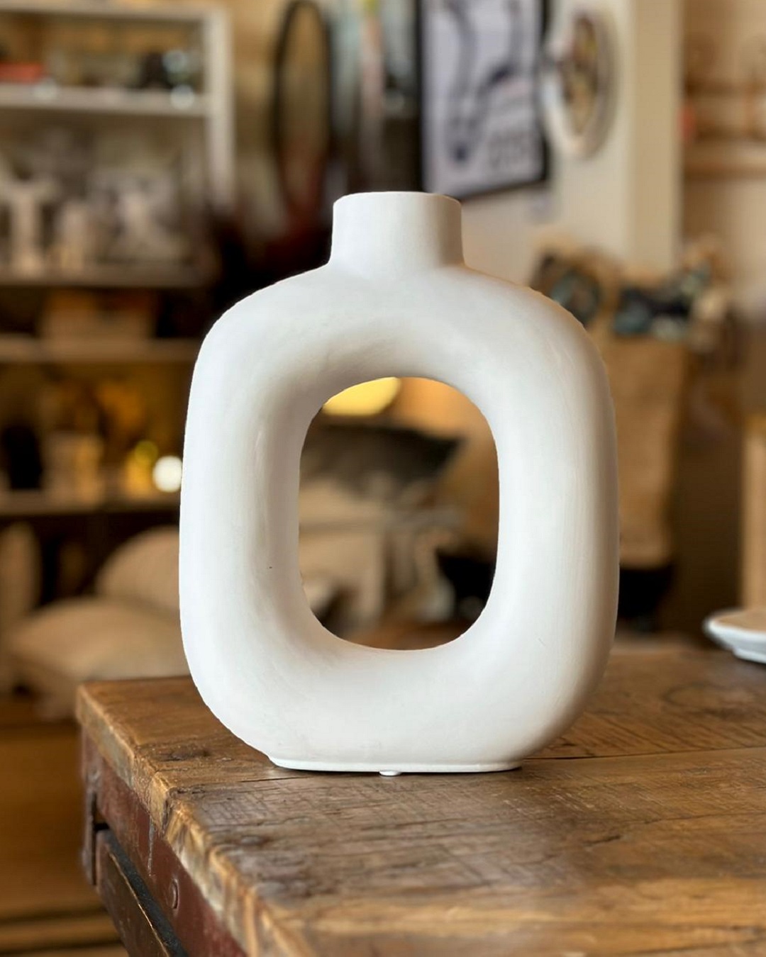 White vase with a whole in the middle