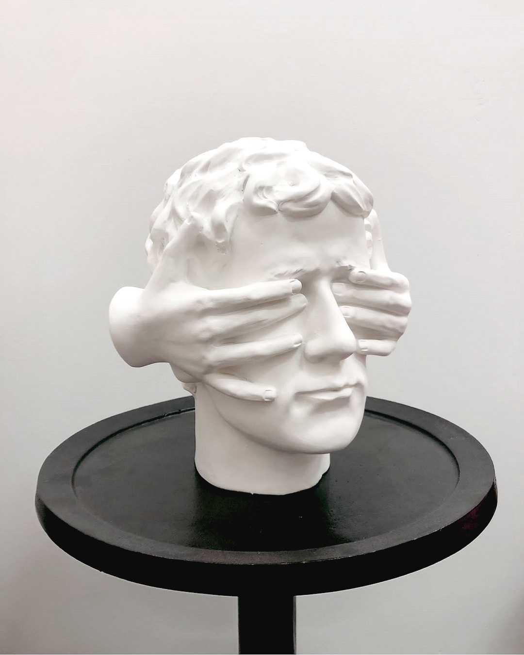 Hands over eye sculpture