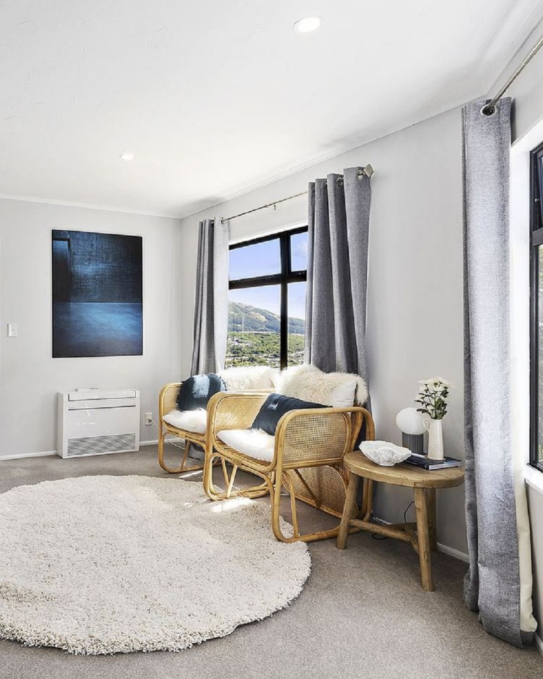 Cane chairs with white cushions in lounge