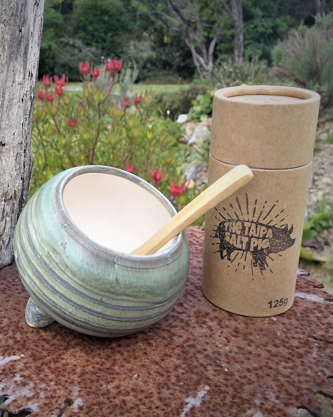 Salt bowl in green and grey with container of salt next to it