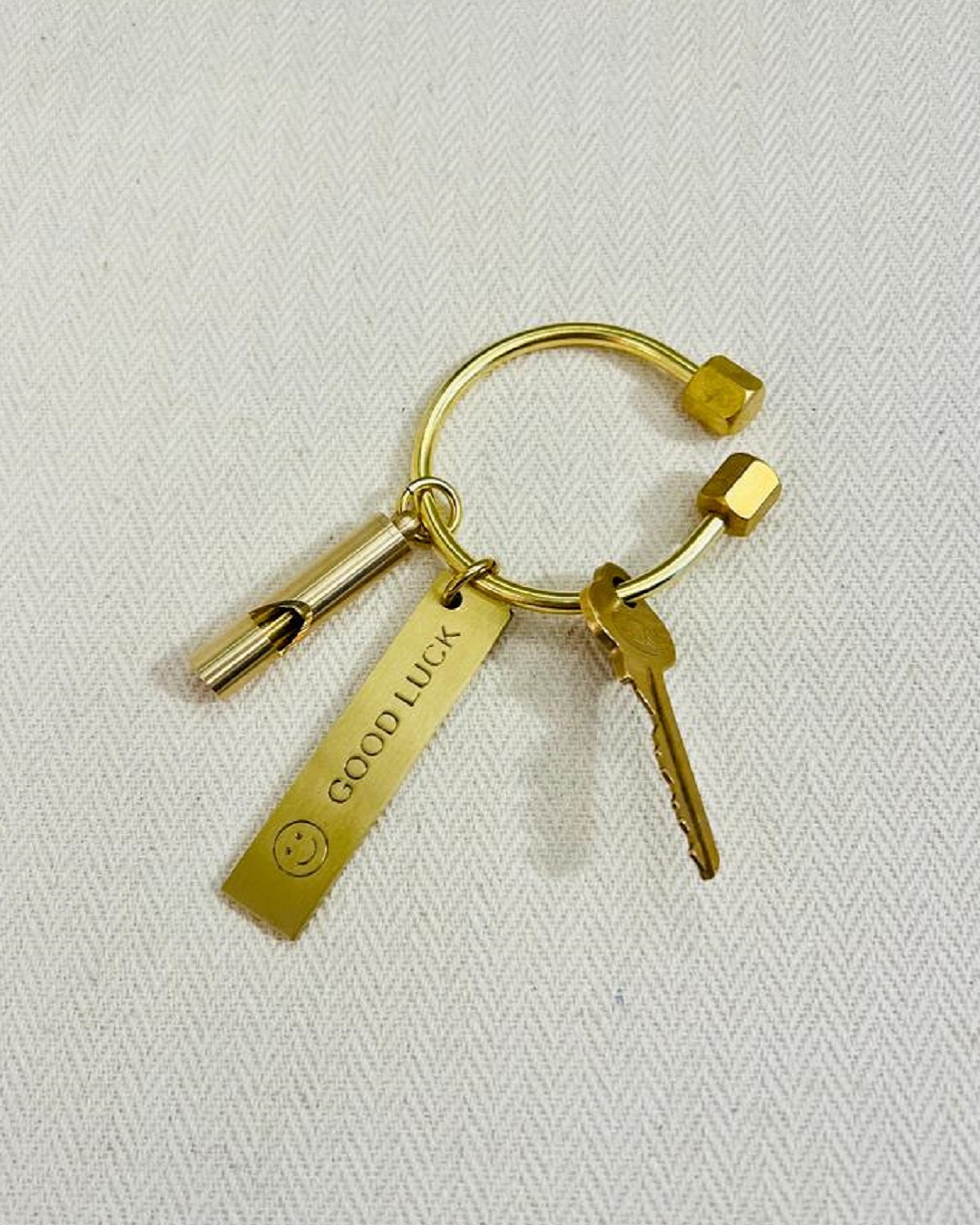 Brass keyring with key and other keyrings on it