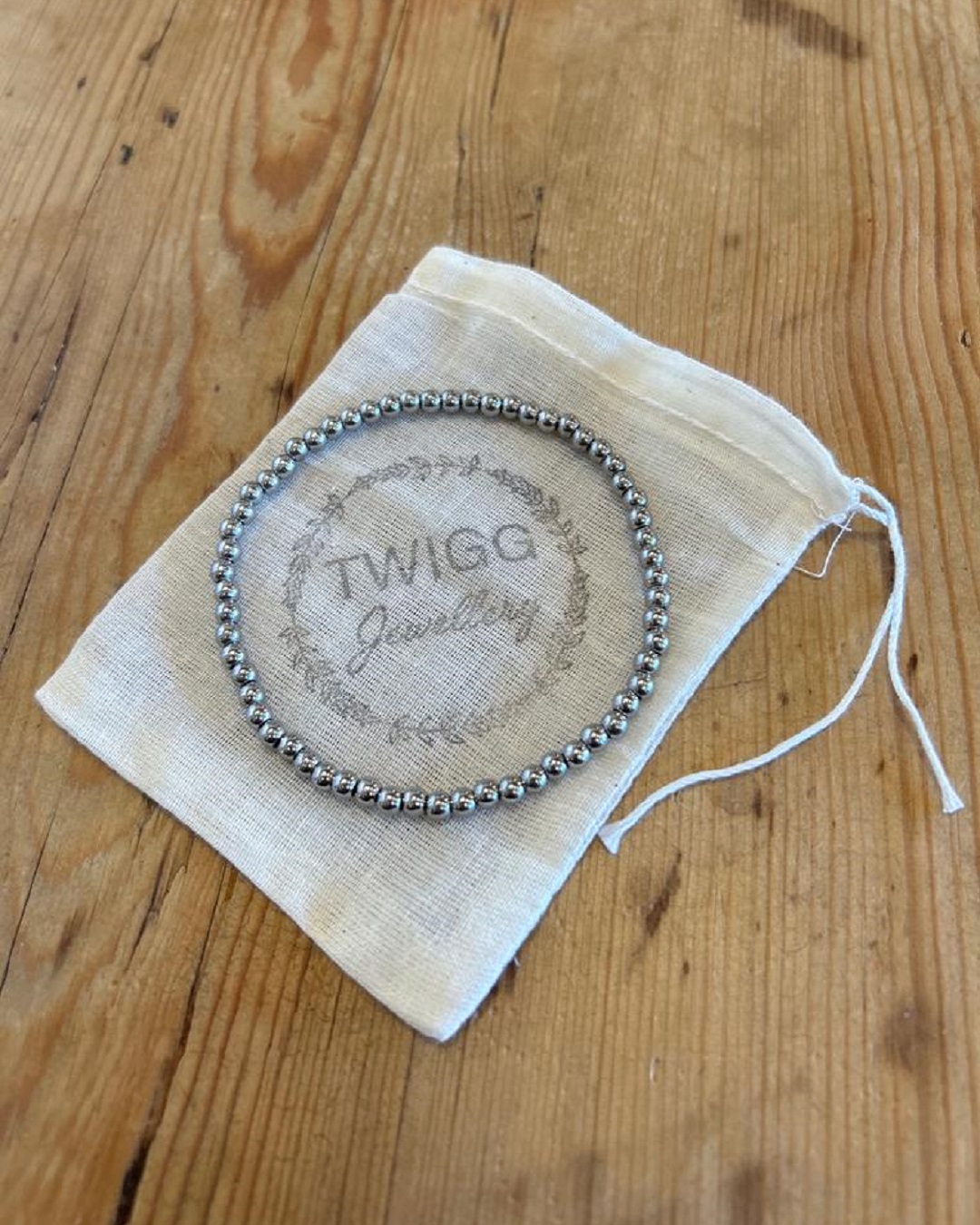 Silver bracelet on a jewellery bag