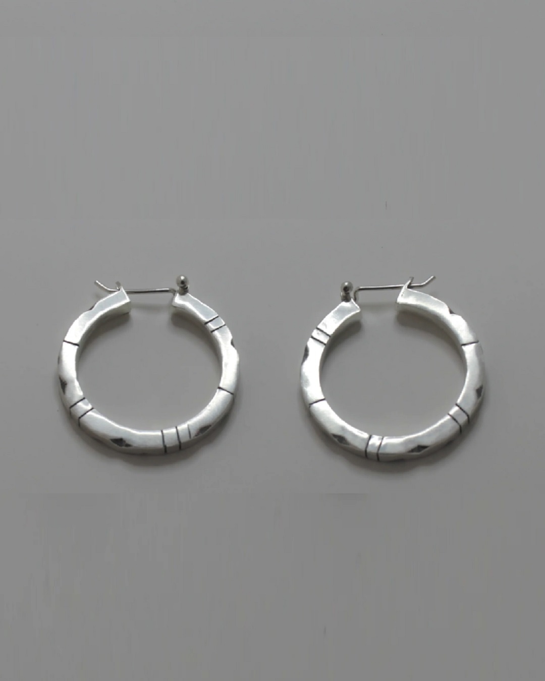 Lined and dented hoop sleeper silver earrings