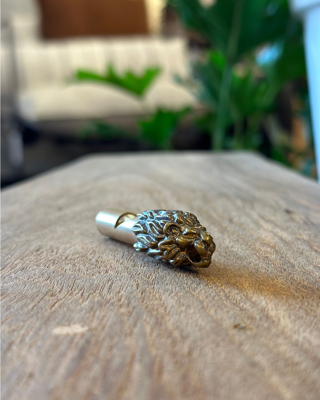 Gold lion keyring on a table
