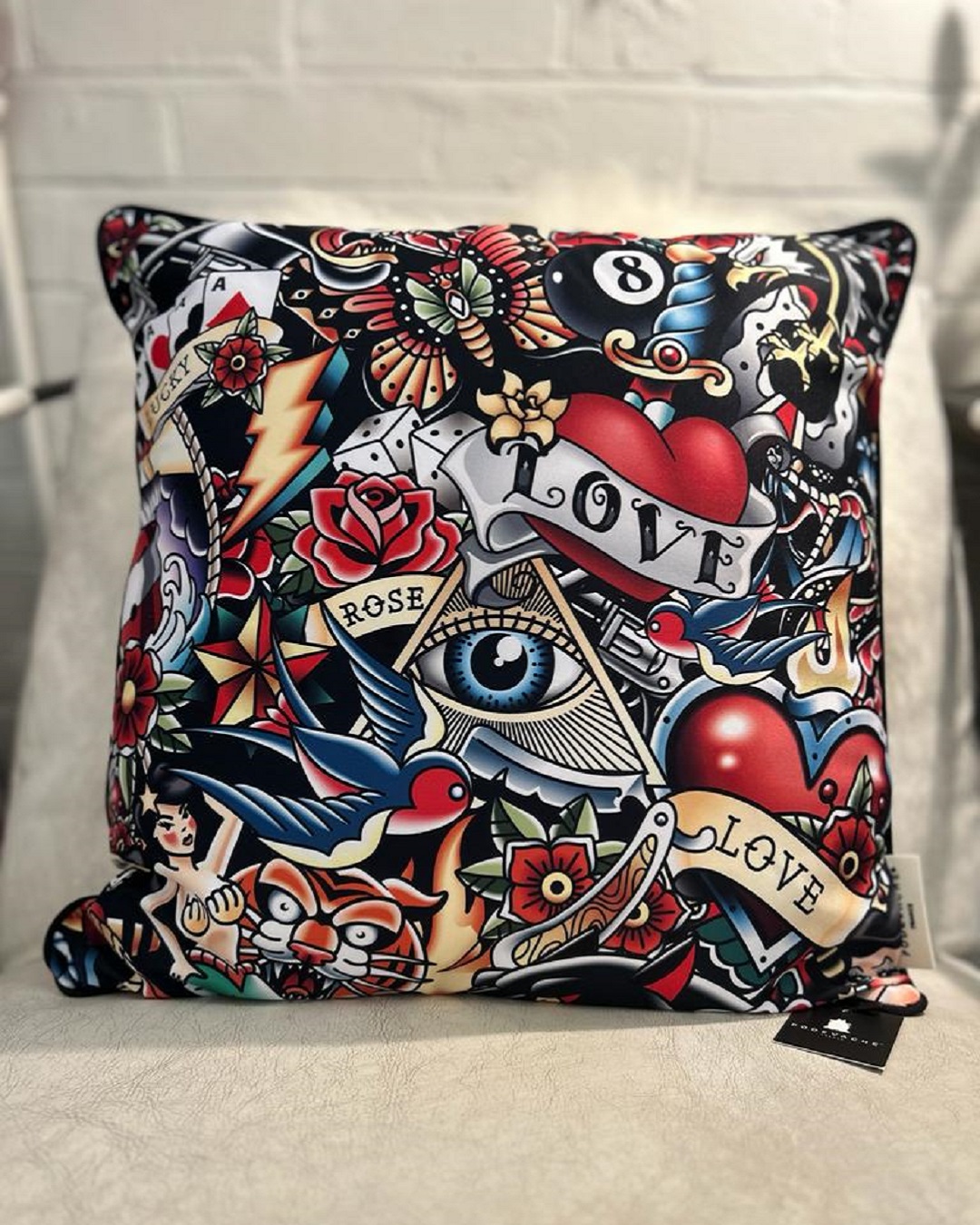 Red black and blue abstract cushion with various rocker designs on it