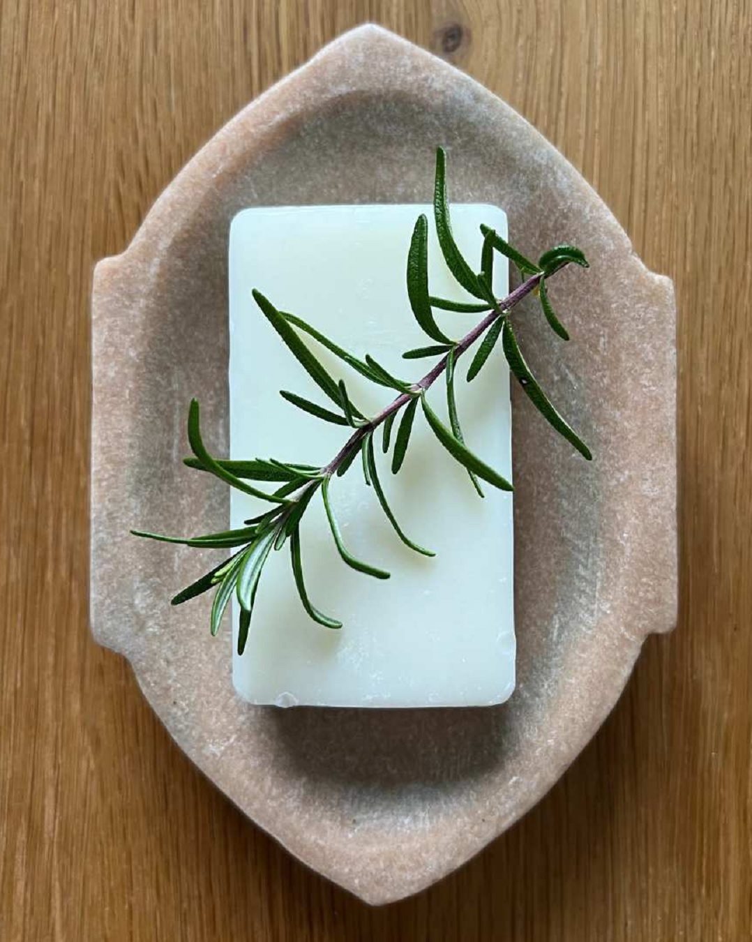 Sand coloured marble soap dish with soap and leaf
