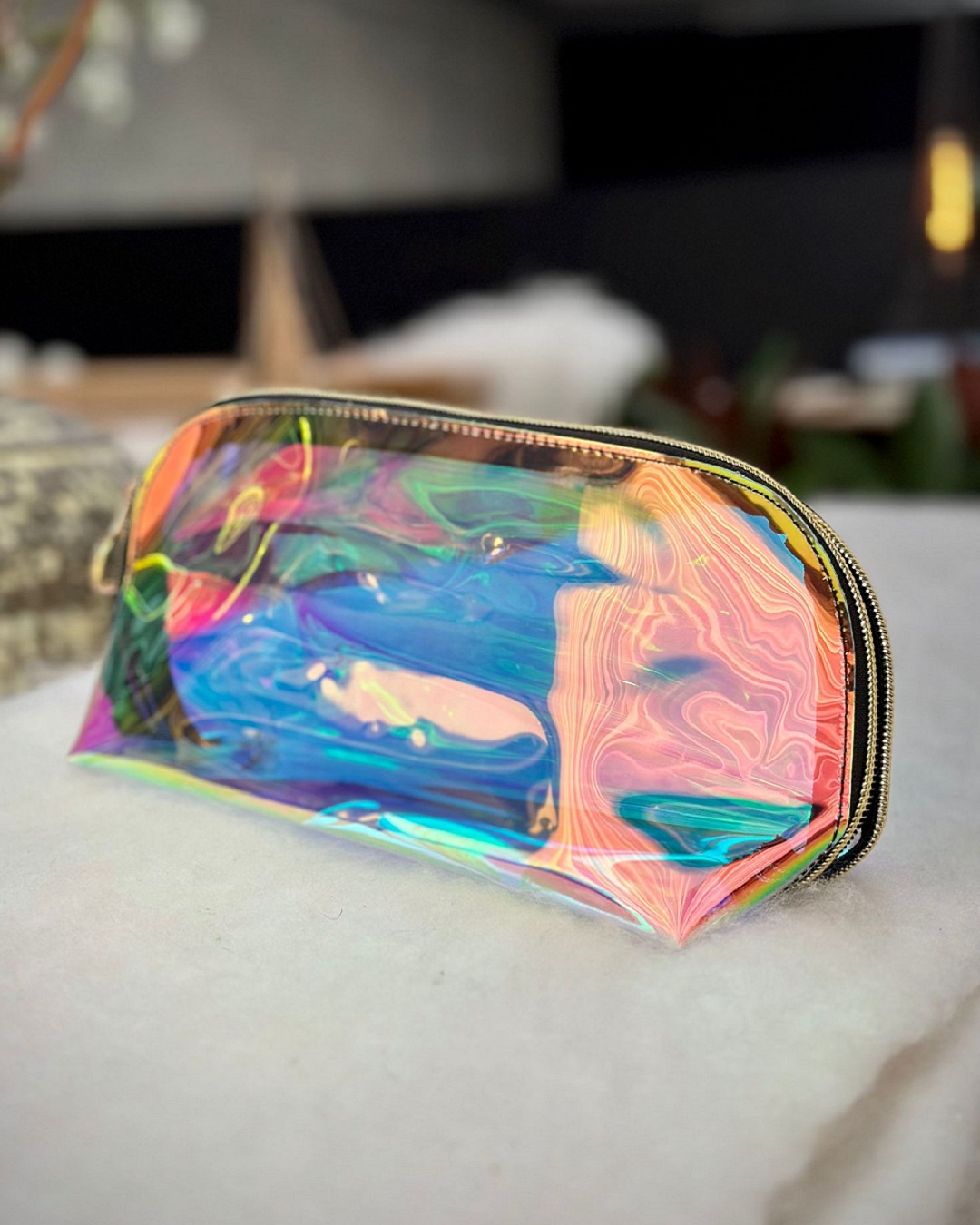 Metallic cosmetic bag on table