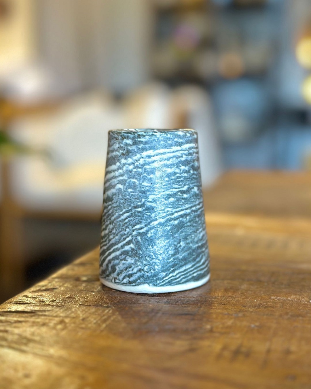 Black and white vase on wooden table