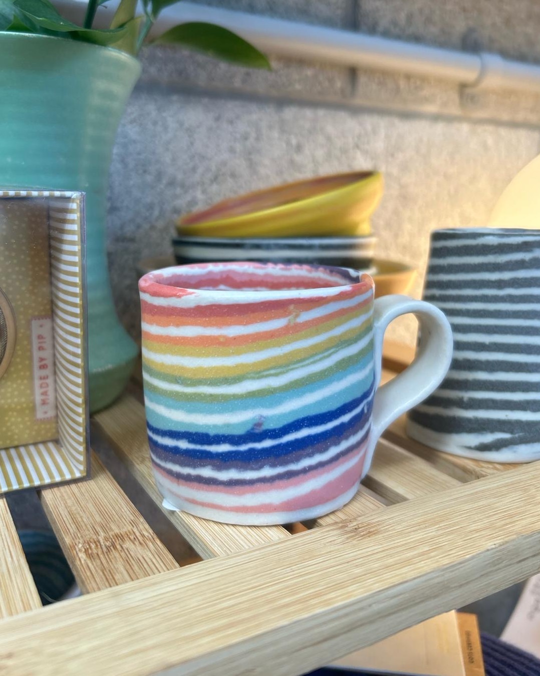 Nerikomi striped rainbow mug on wooden shelf