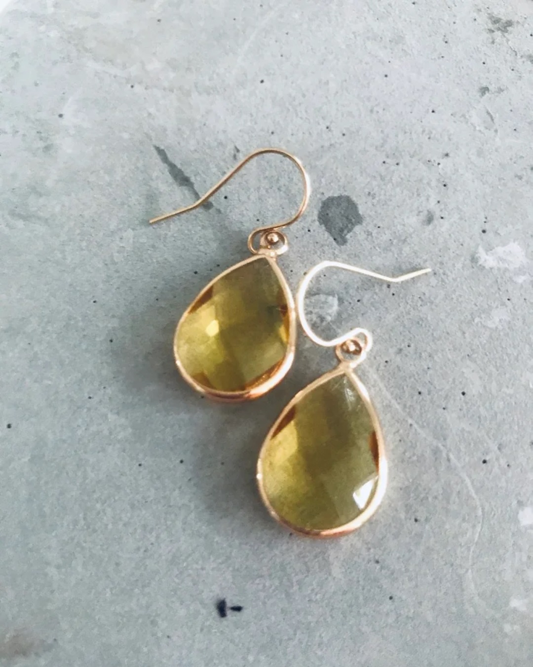 Amber gem drop earrings on grey stone