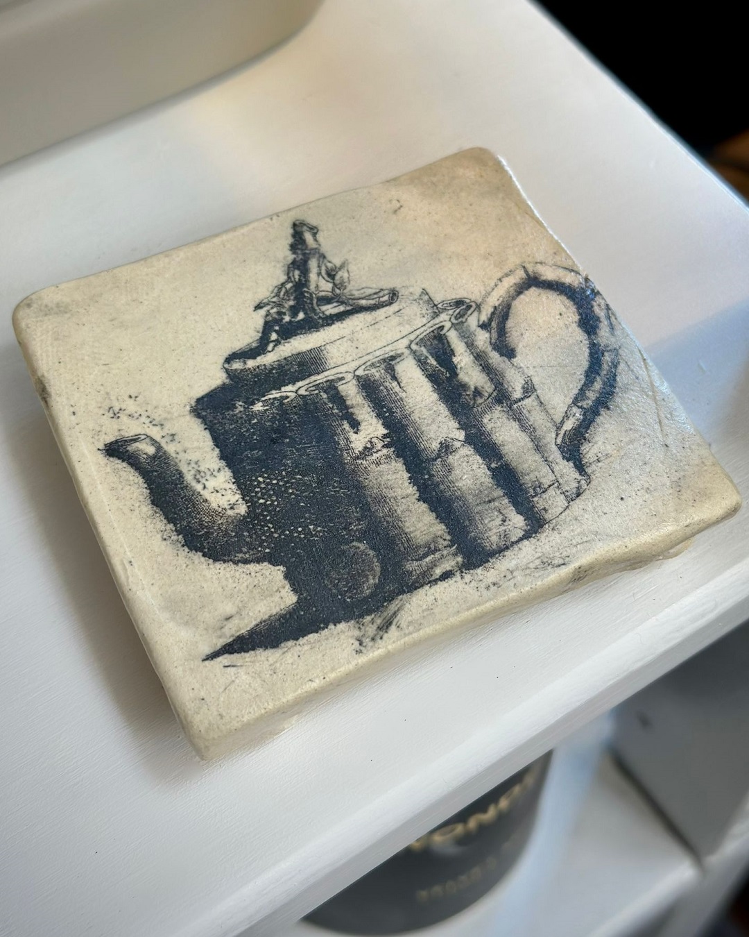Square plinth with teapot print on it