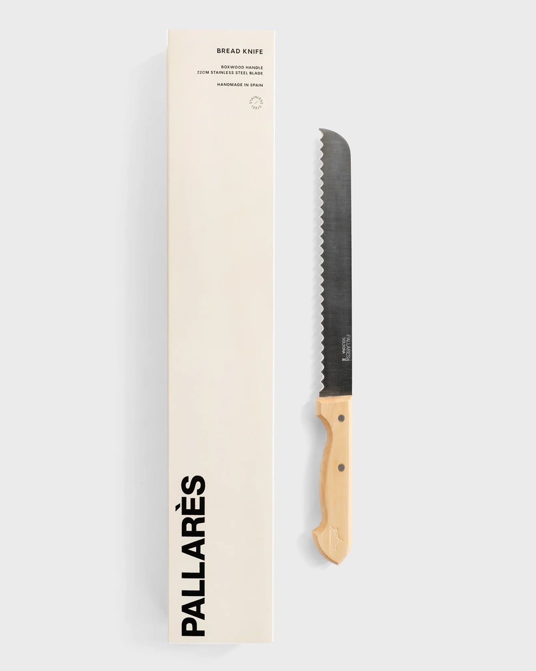 Bread knife with wooden handle next to box