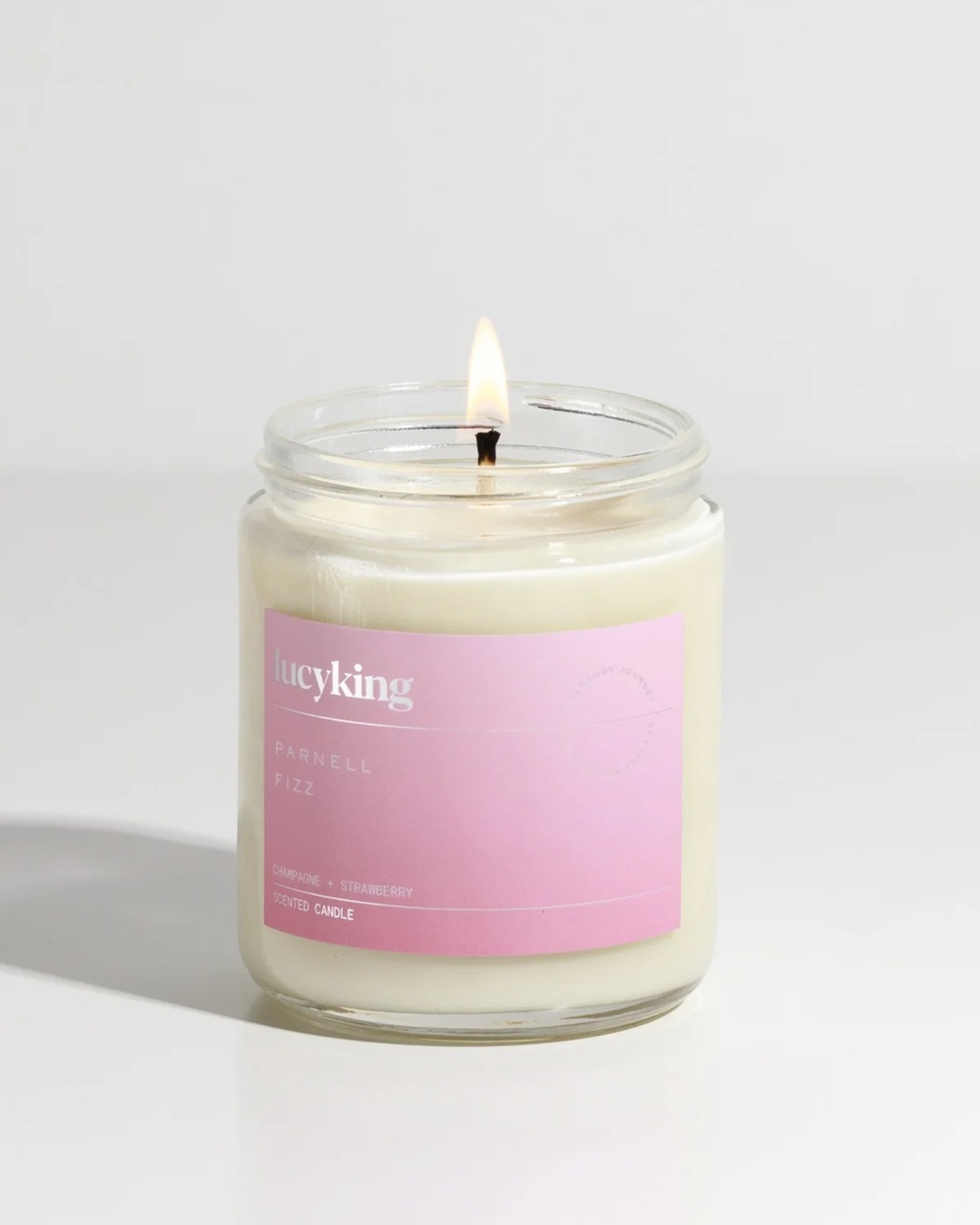 Glass jar candle with pink label
