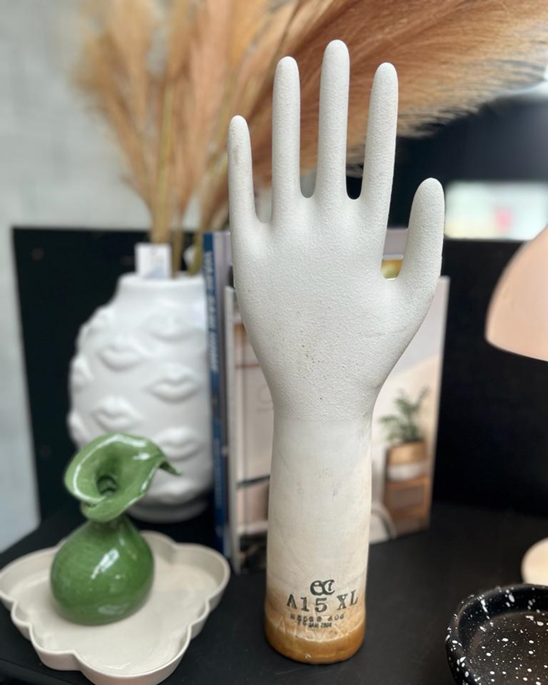 White glove mould on a table with vases