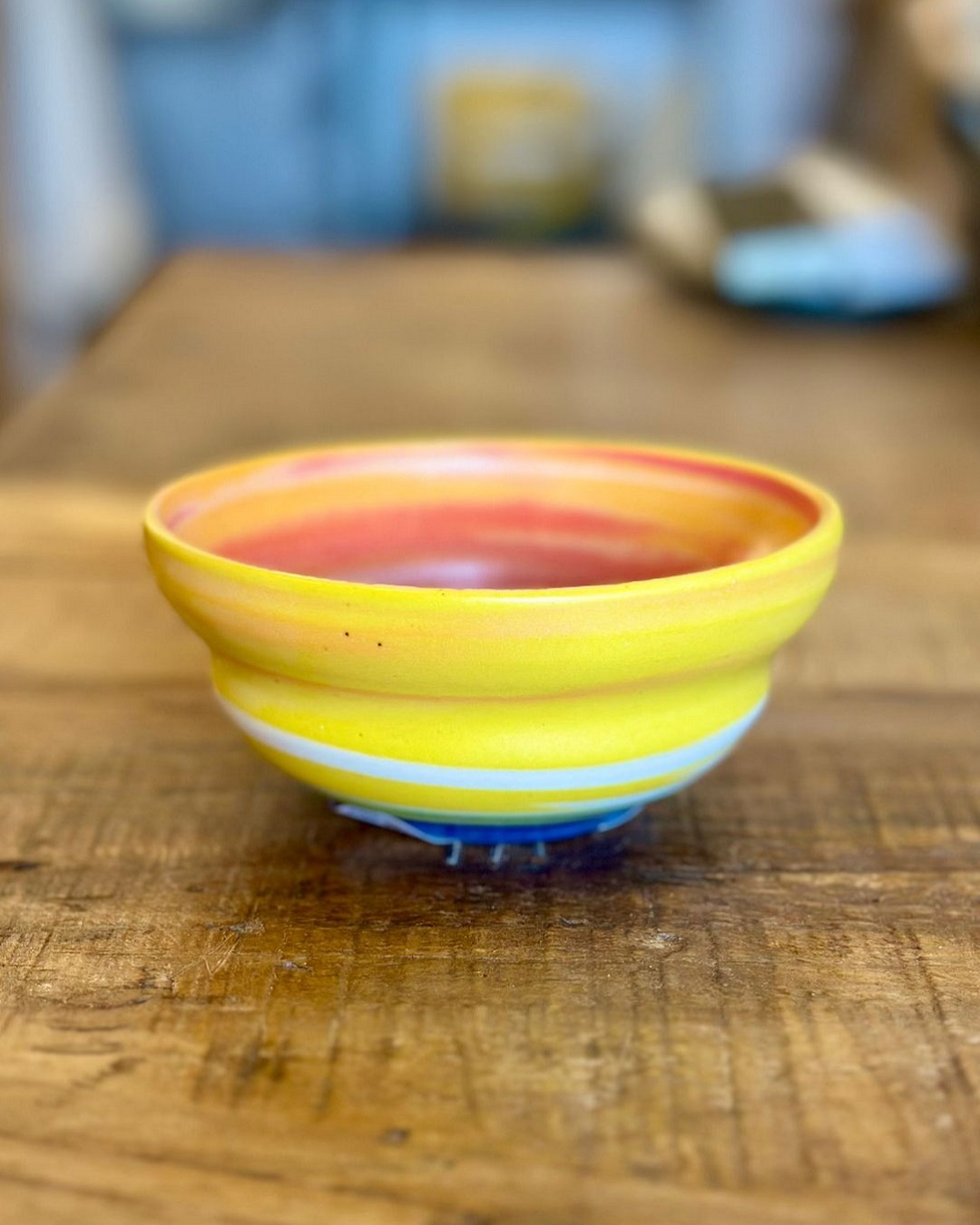 Rainbow ceramic bowl on wooden table